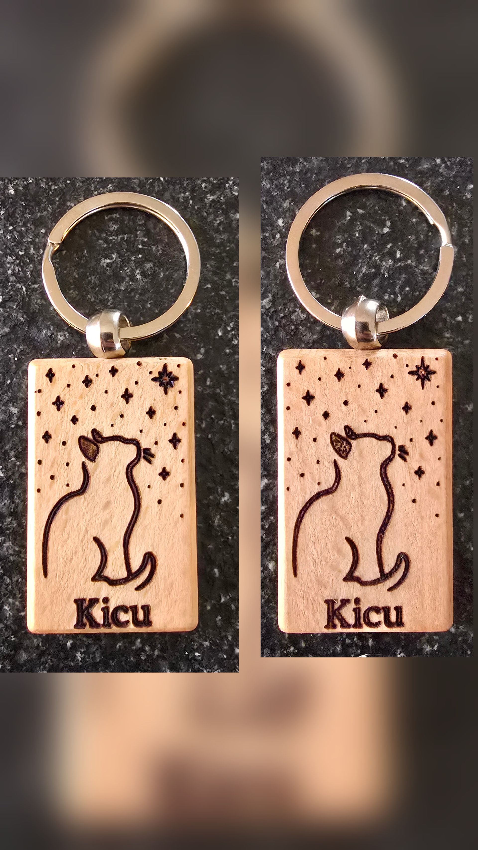 Two wooden keychains with a cat silhouette, stars, and the name 