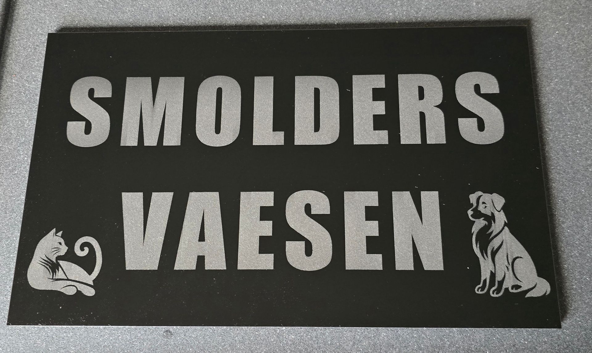 Black sign with engraved text 