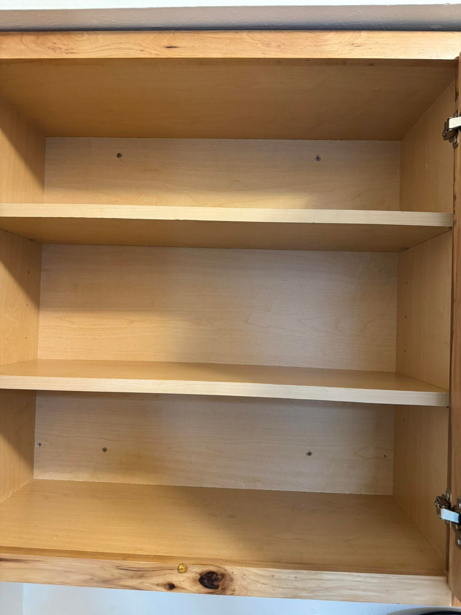 Empty wooden cabinet with three shelves.