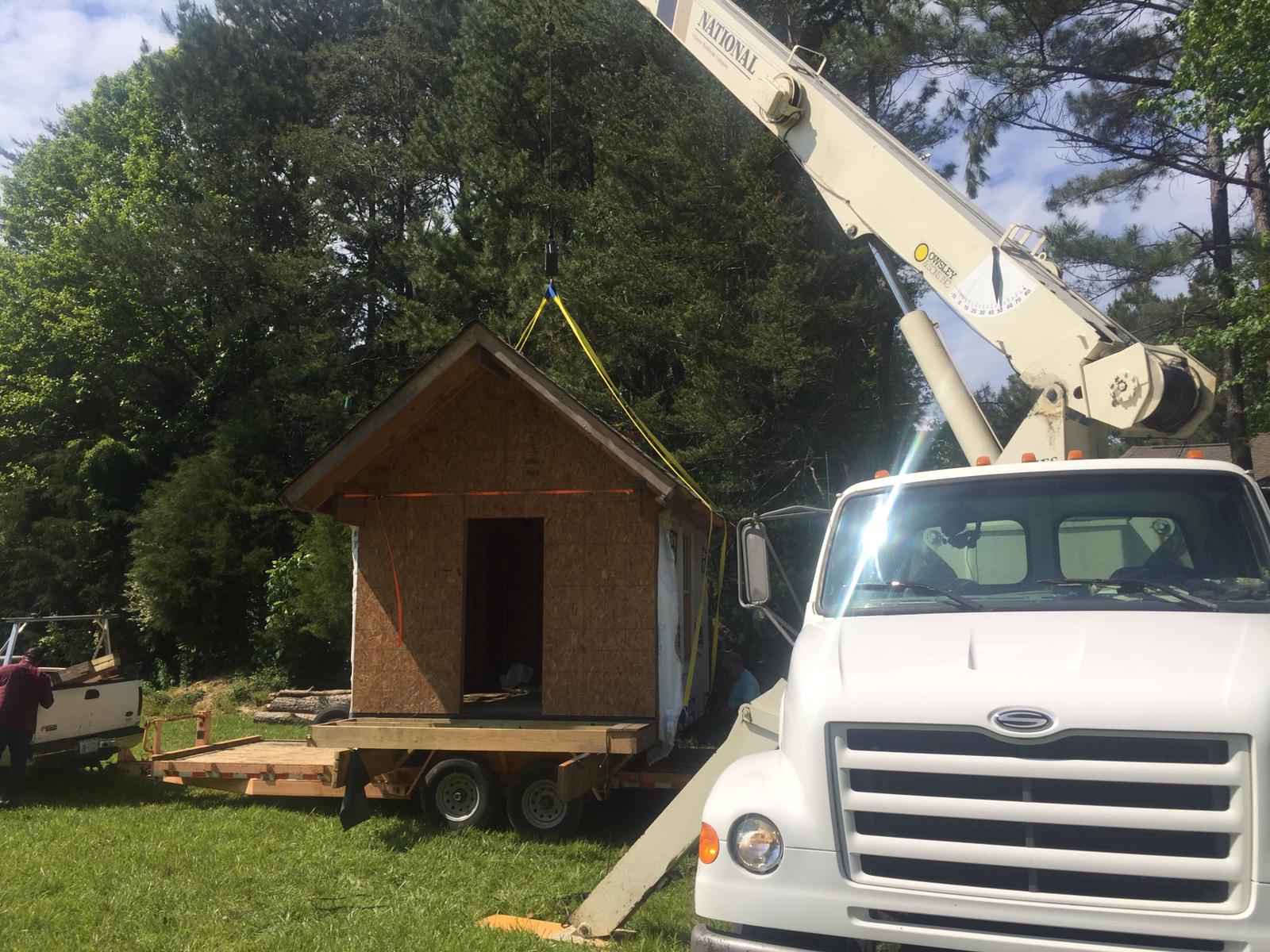 Crane service starting to lift pre-built treehouse in Statesville, NC