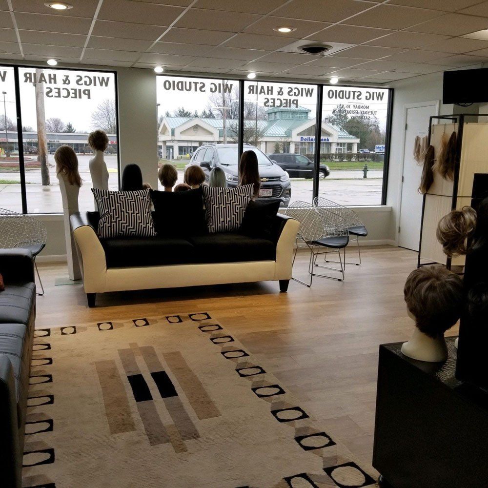 Couch with Pillows Inside the Store — Strongsville, OH — Wig Studio LLC