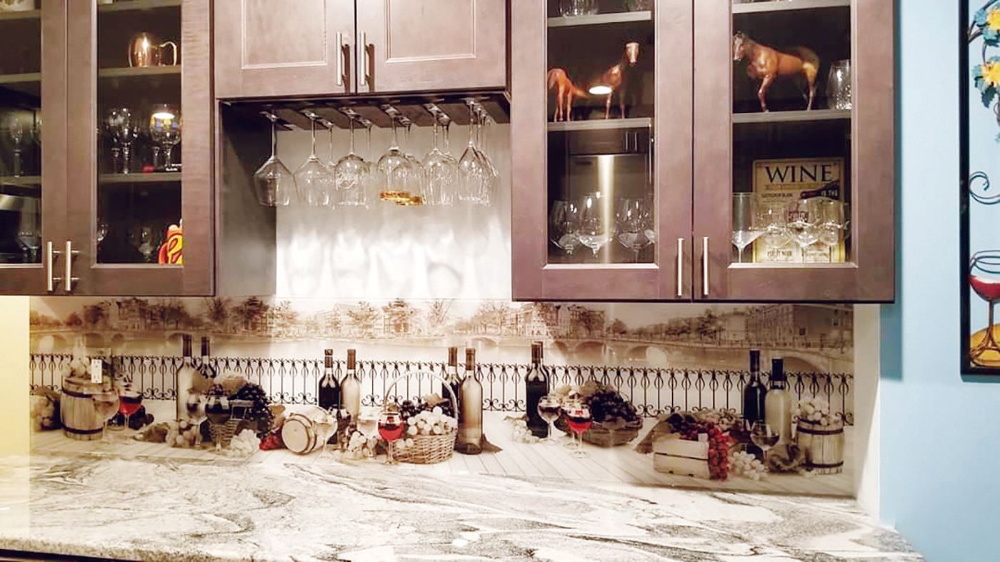 Kitchen with wine glasses, bottles, and decor in a rustic setting.