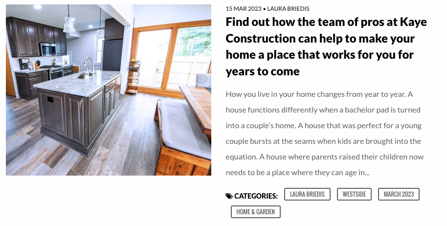 Kitchen renovation with a gray island and wooden cabinets.