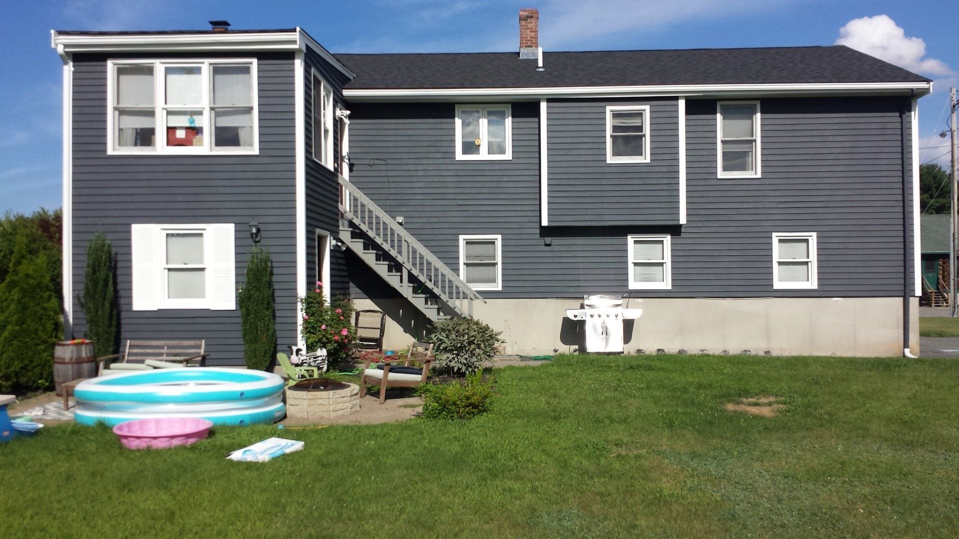 a large house with a swimming pool in front of it