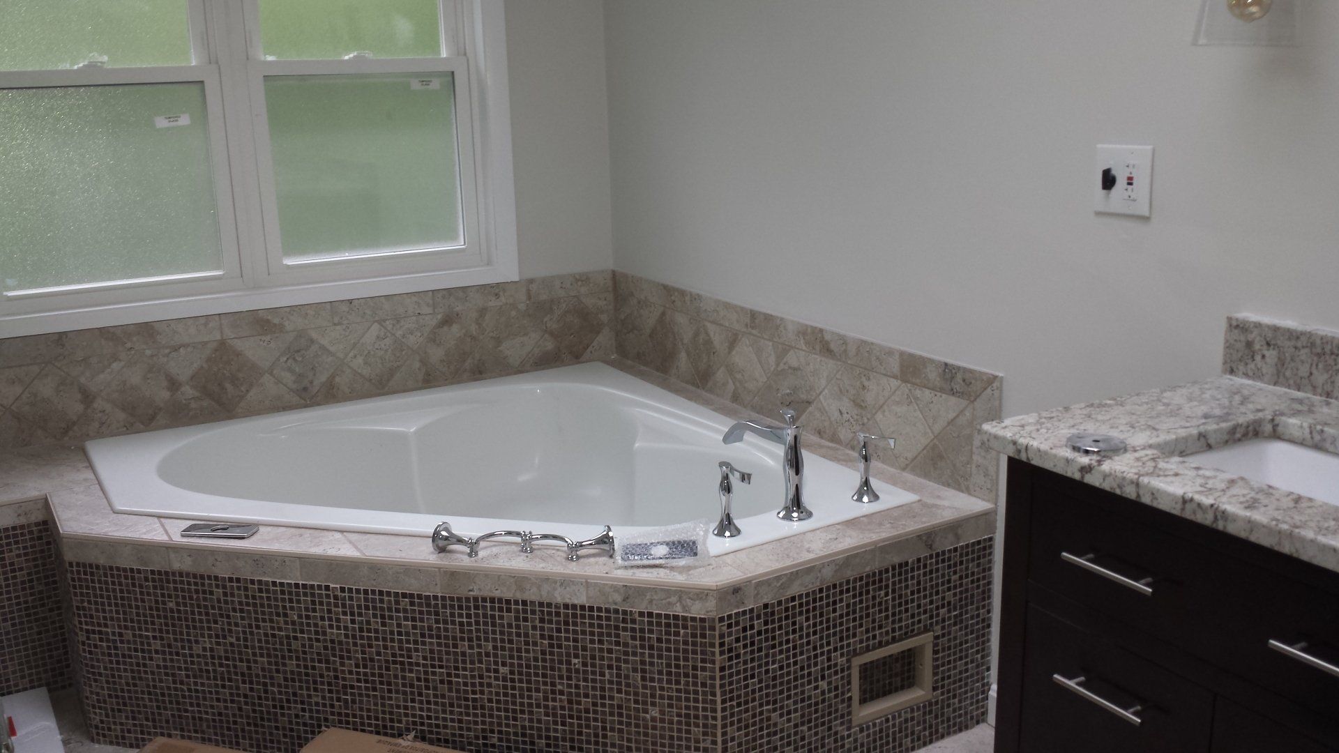 a bathroom with a jacuzzi tub and a sink.