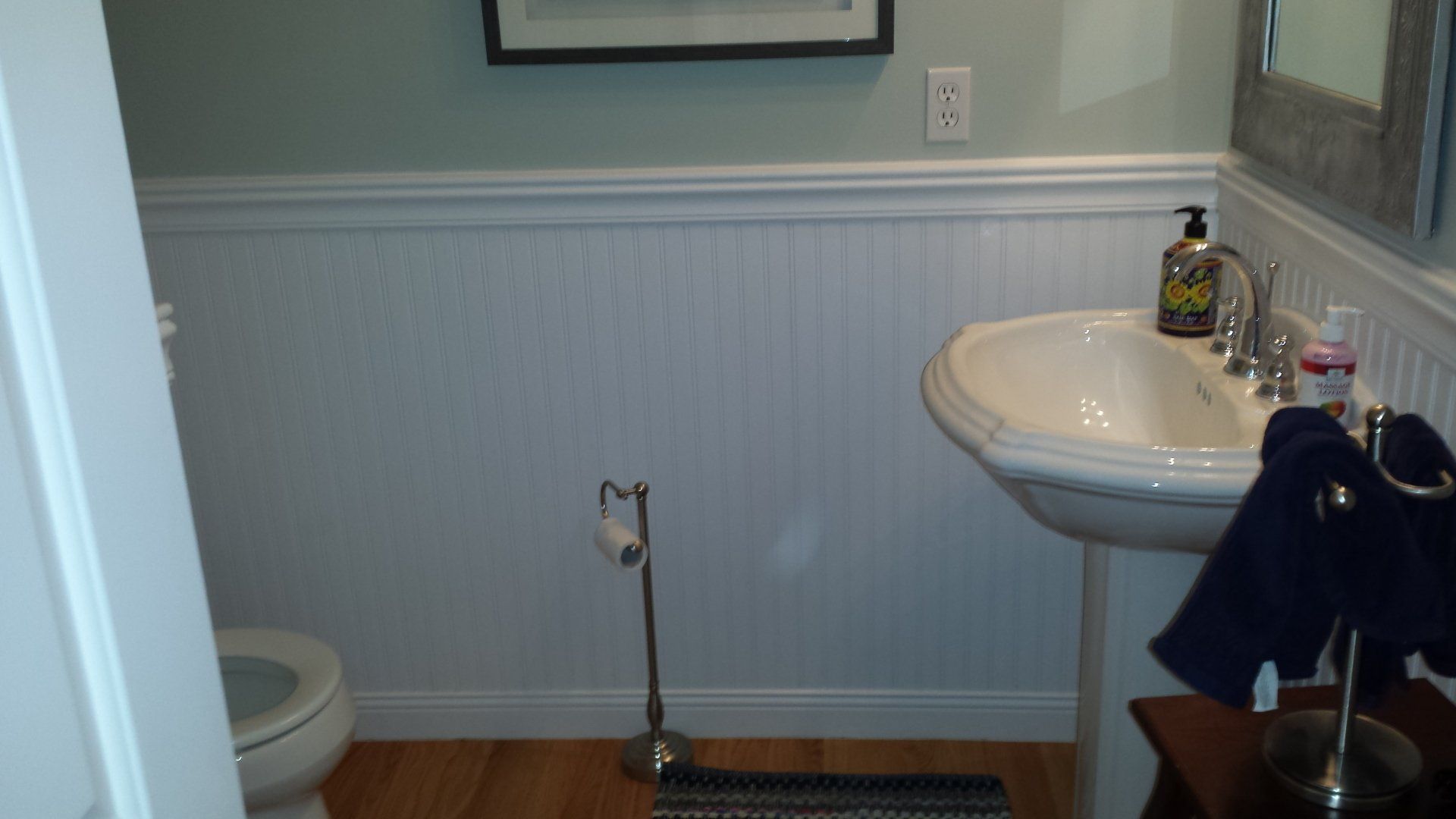 a bathroom with a toilet a sink and a mirror