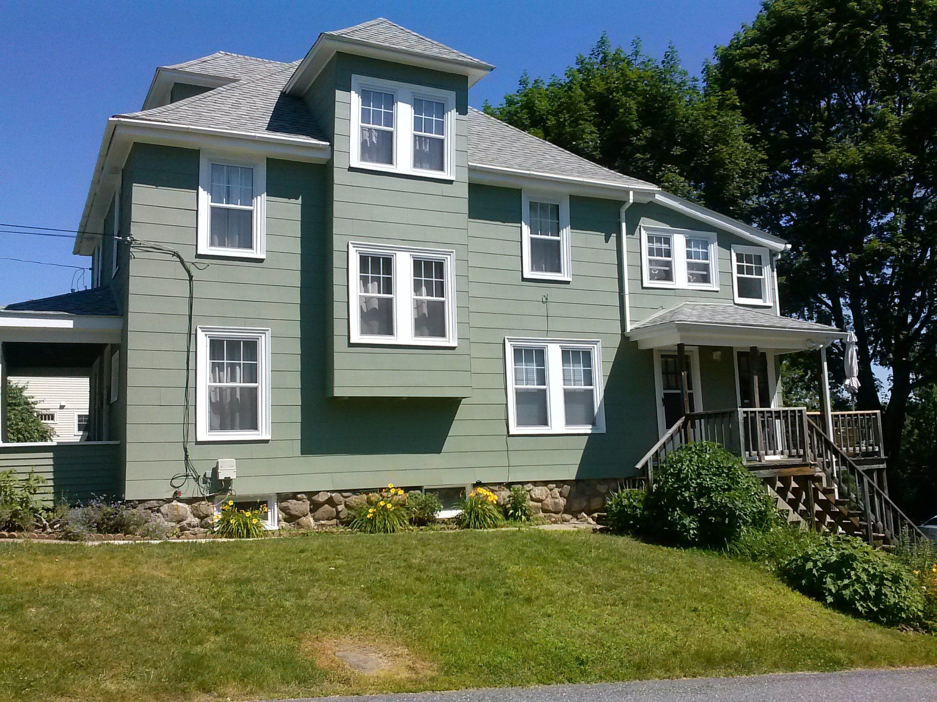 a green house with a lot of windows on a sunny day