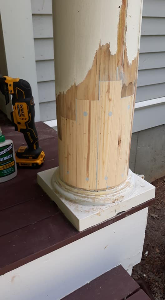 A wooden pillar is being removed from a porch with a drill.
