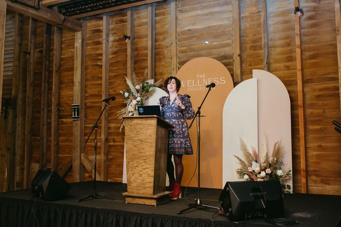A woman is standing at a podium giving a speech.