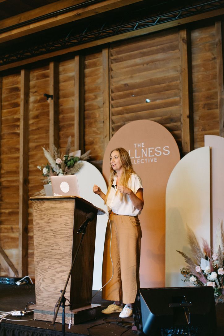 A woman is standing at a podium giving a speech.