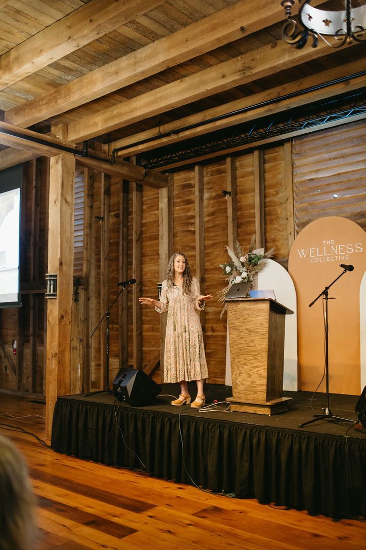 A woman is standing on a stage giving a speech.
