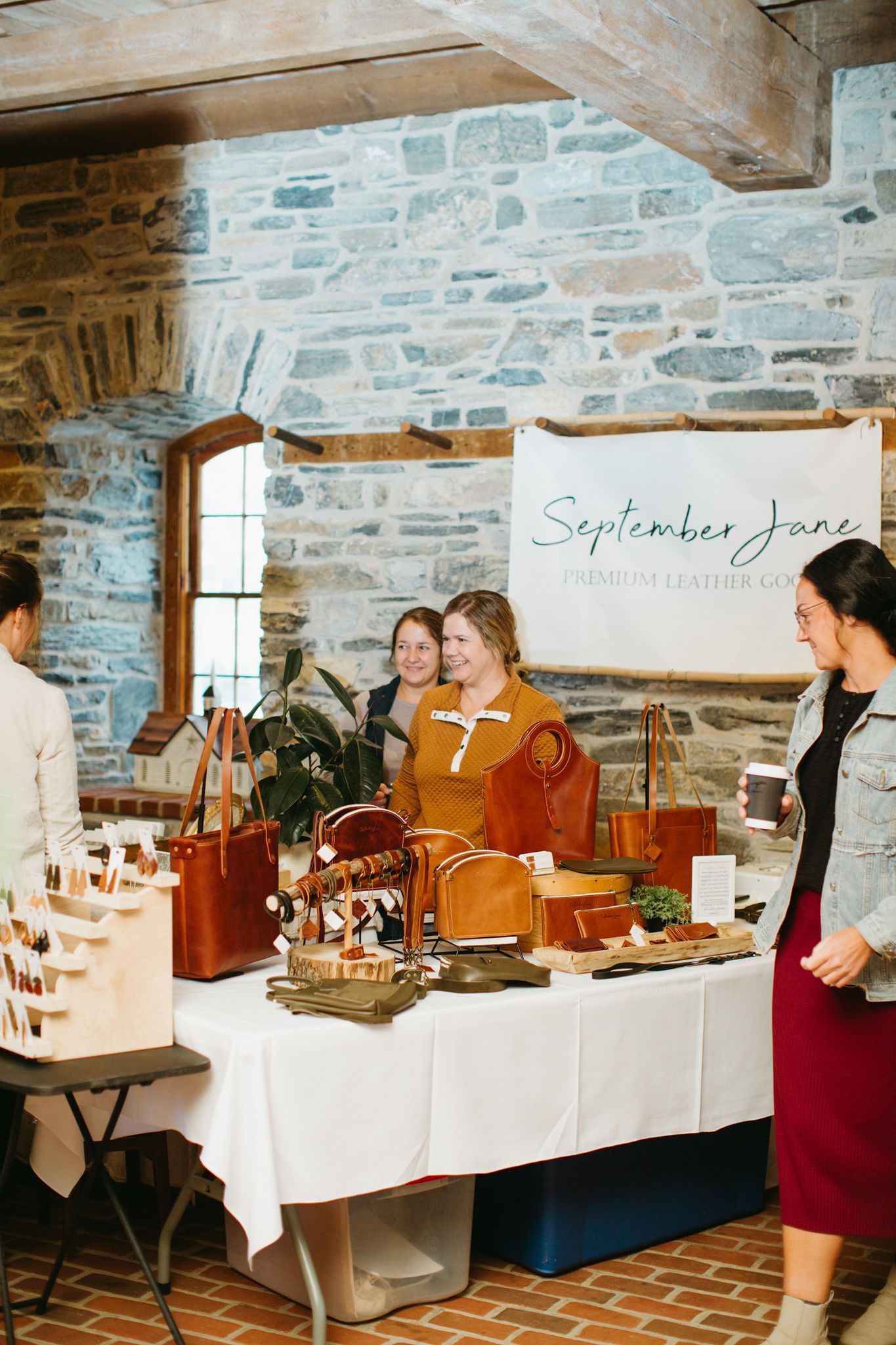 A group of women are standing around a table in a room.