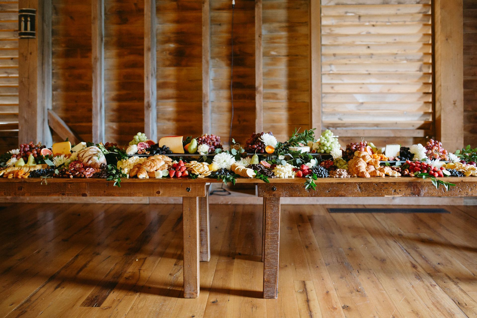 A long wooden table filled with lots of fruits and vegetables.