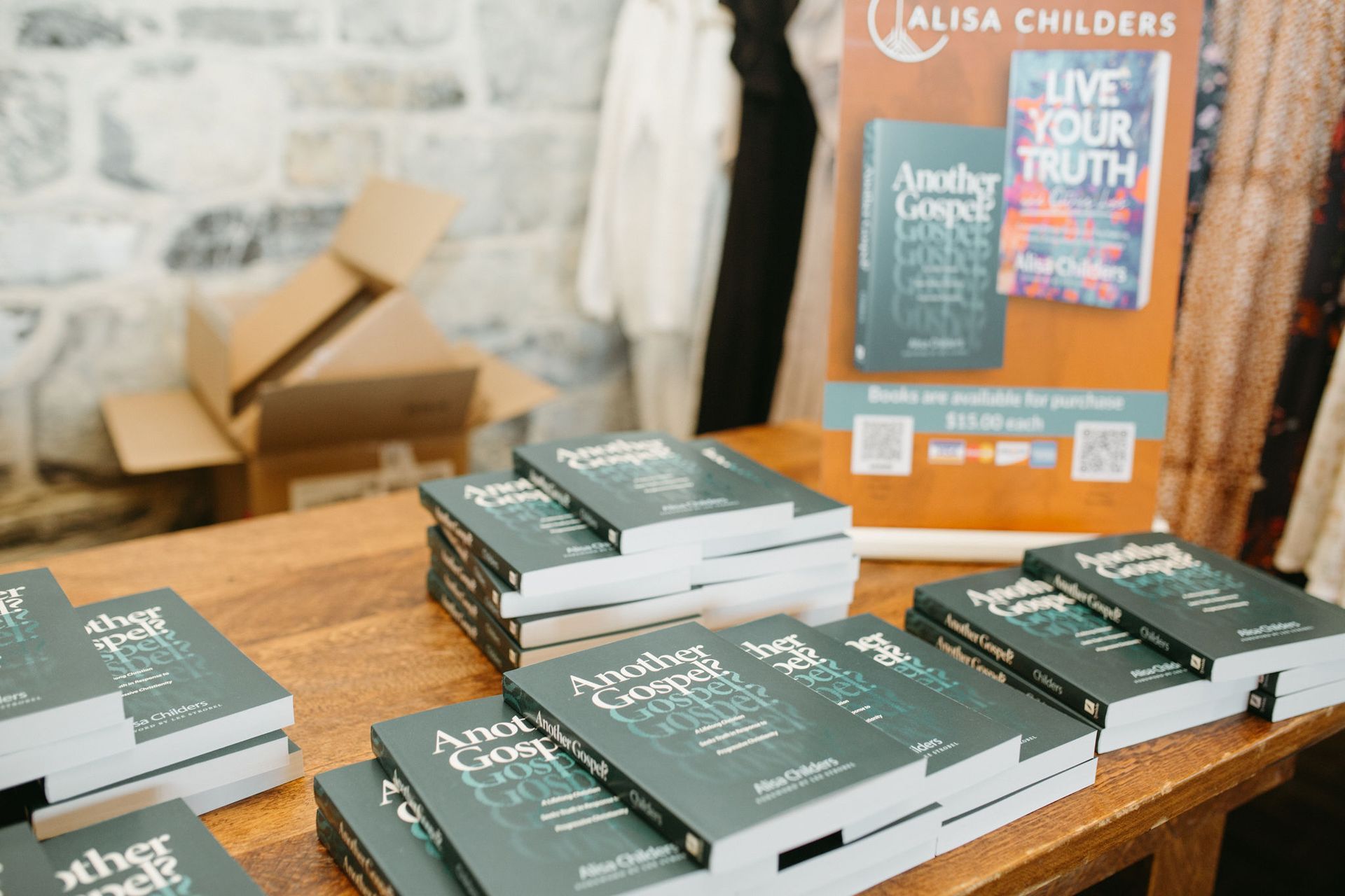 A stack of books sitting on top of a wooden table.