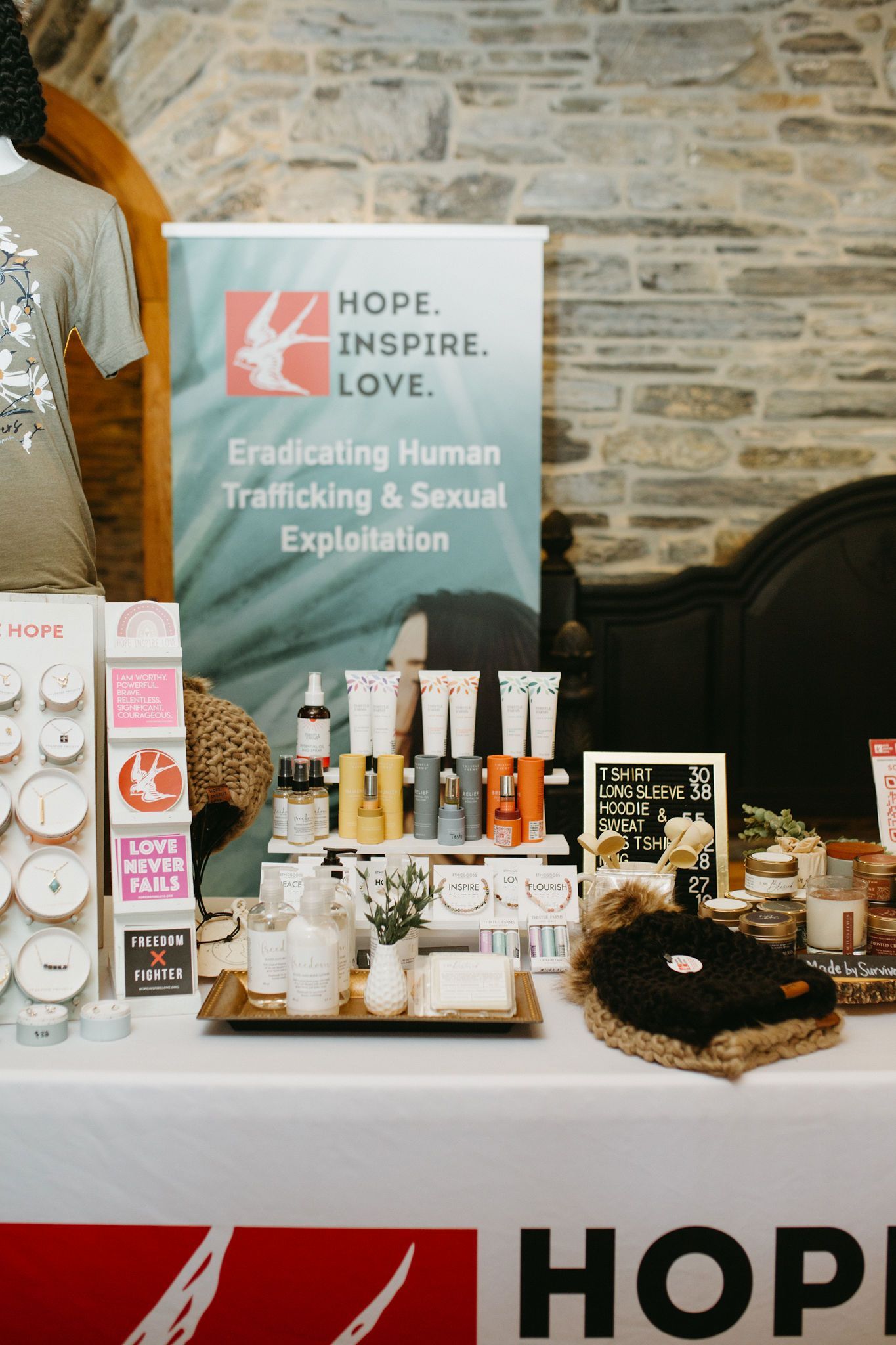 A table with a sign that says hope inspire love on it