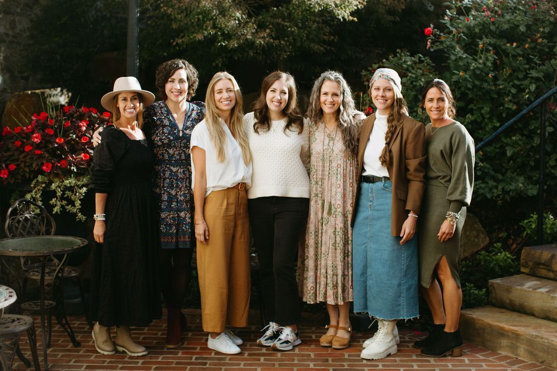A group of women are posing for a picture together.
