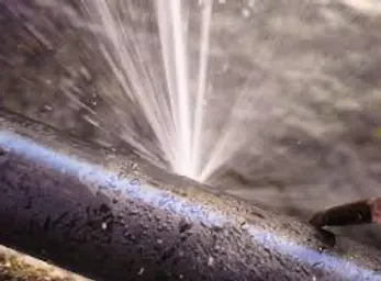 A close up of a pipe with water coming out of it.