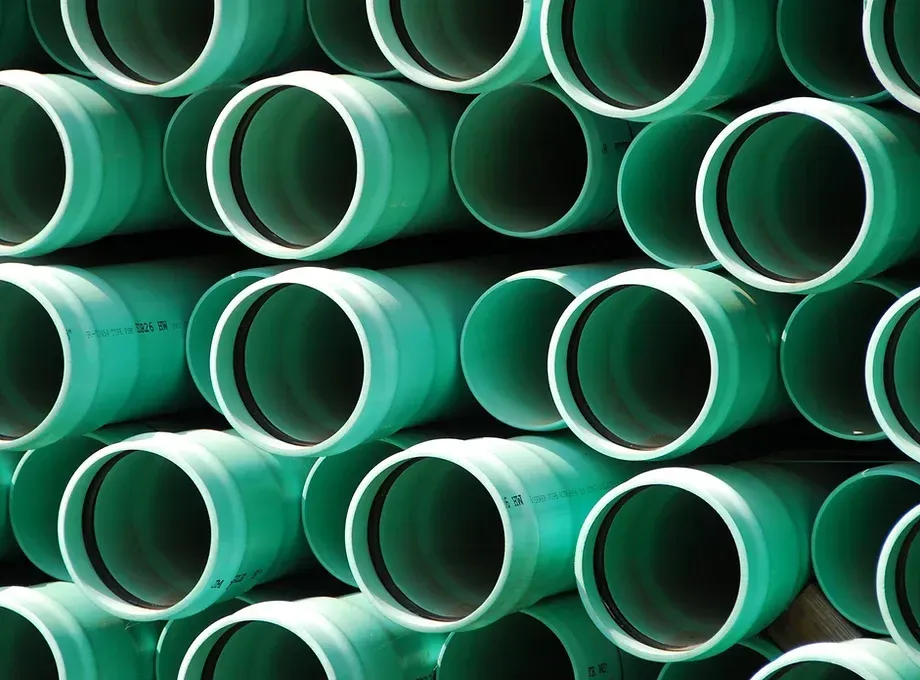 A bunch of green pipes stacked on top of each other