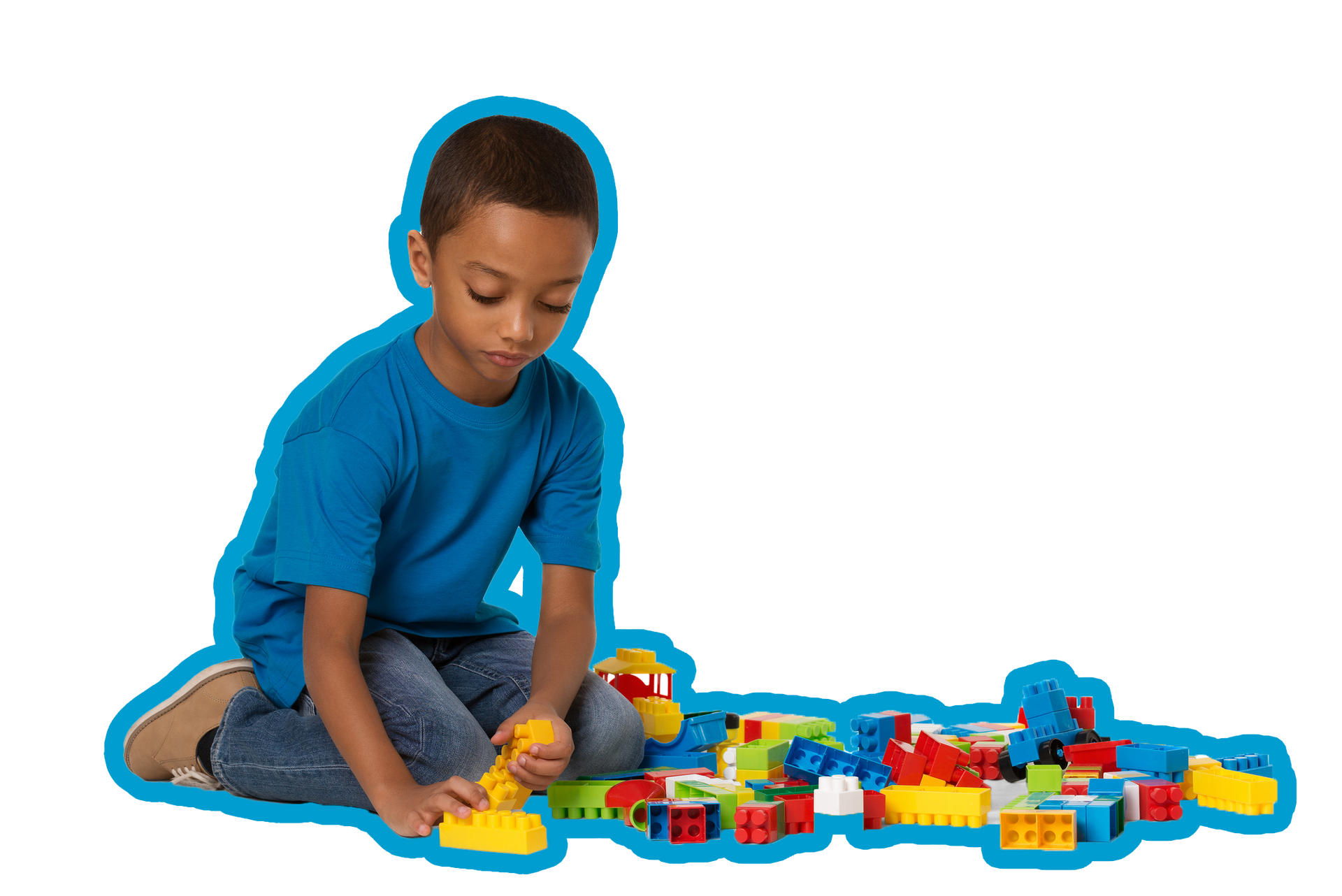 Boy in blue shirt and jeans playing with colorful building blocks.