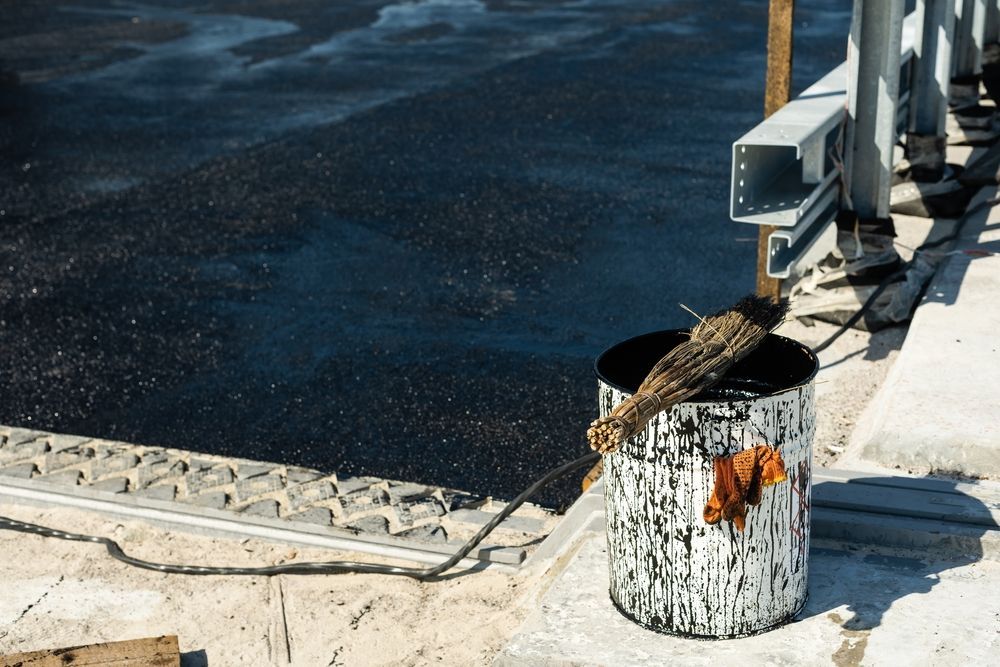 Bucket of Tar With Brush Next to Freshly Paved Surface — 1 Time Waterproofing In East Ballina, NSW