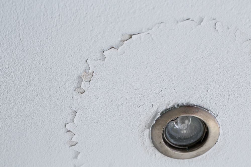 Flaking Paint on a White Ceiling Around a Recessed Light Fixture — 1 Time Waterproofing In Lismore, NSW