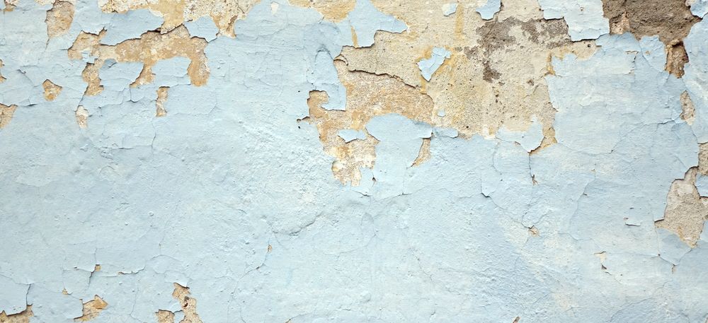 Old Wall With Peeling Blue Paint, Revealing Beige Plaster Beneath — 1 Time Waterproofing In East Ballina, NSW