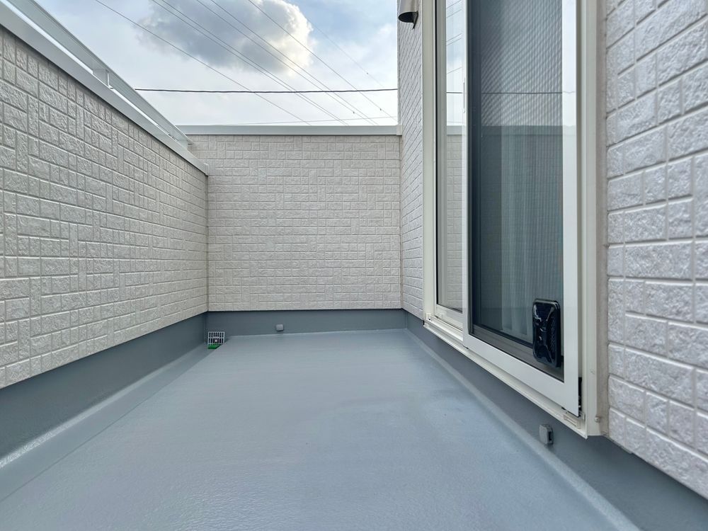 A Small Outdoor Balcony With White Brick Walls and a Sliding Glass Door — 1 Time Waterproofing In East Ballina, NSW