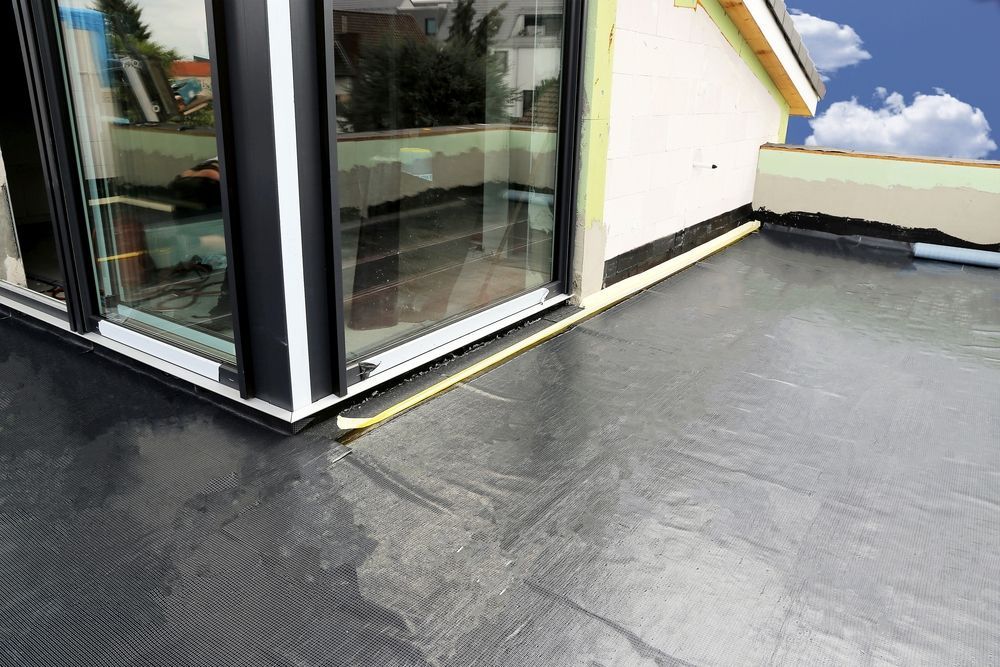Black Roofing Material Around a Building's Corner With Large Windows — 1 Time Waterproofing In East Ballina, NSW