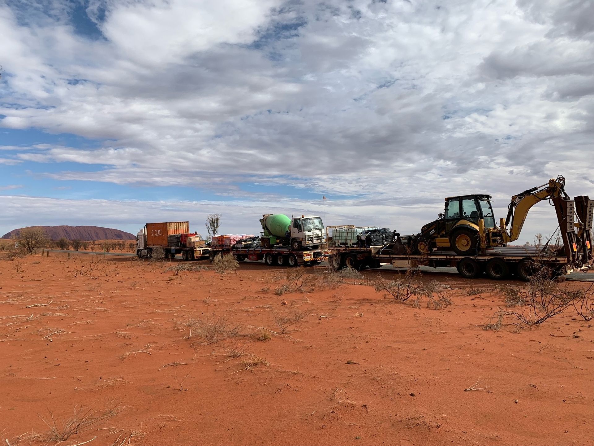 A Group Of Construction Vehicles Are Parked In A Dirt Field — SLS Builders Pty Ltd in Humpty Doo, NT