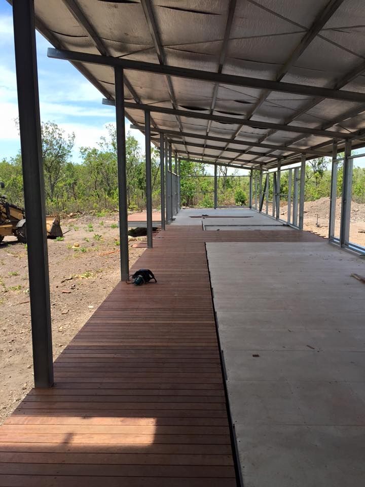 A Wooden Deck Under A Metal Structure In The Middle Of A Field — SLS Builders Pty Ltd in Alice Springs, NT