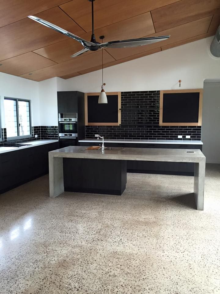 A Kitchen With A Large Island And A Ceiling Fan — SLS Builders Pty Ltd in Katherine, NT