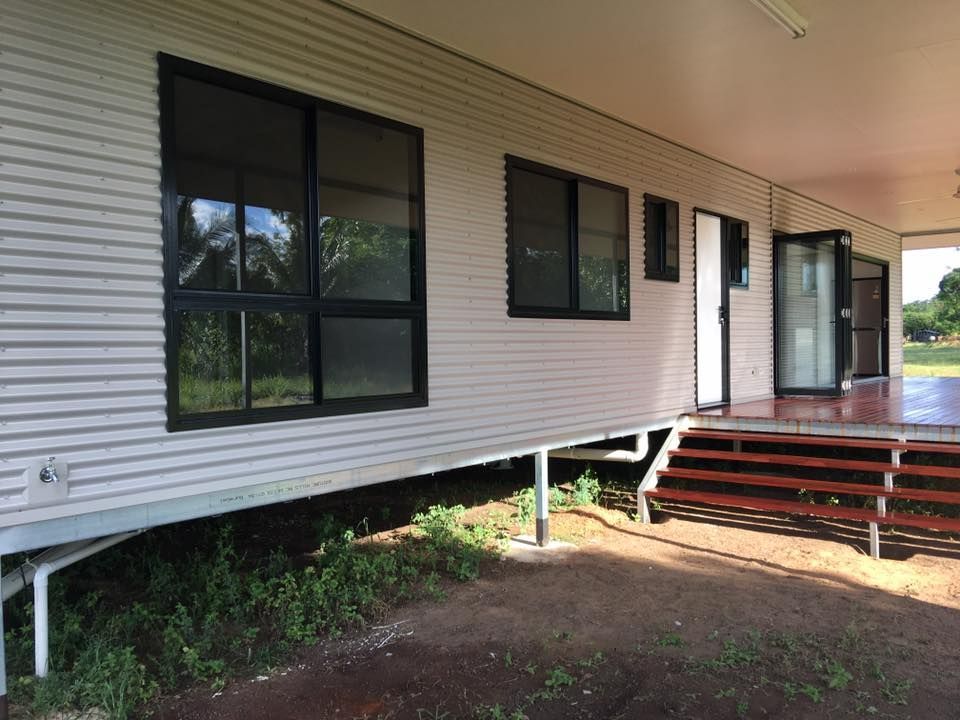 A White House With A Porch And Stairs — SLS Builders Pty Ltd in Alice Springs, NT