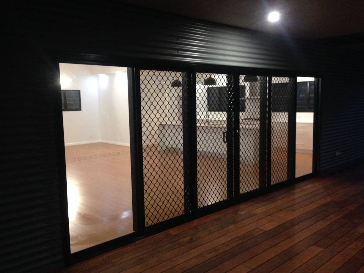 An Empty Room With Sliding Glass Doors And A Wooden Floor in Humpty Doo, NSW