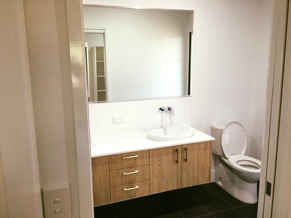 A Bathroom With A Sink , Toilet And Mirror — SLS Builders Pty Ltd in Humpty Doo, NT