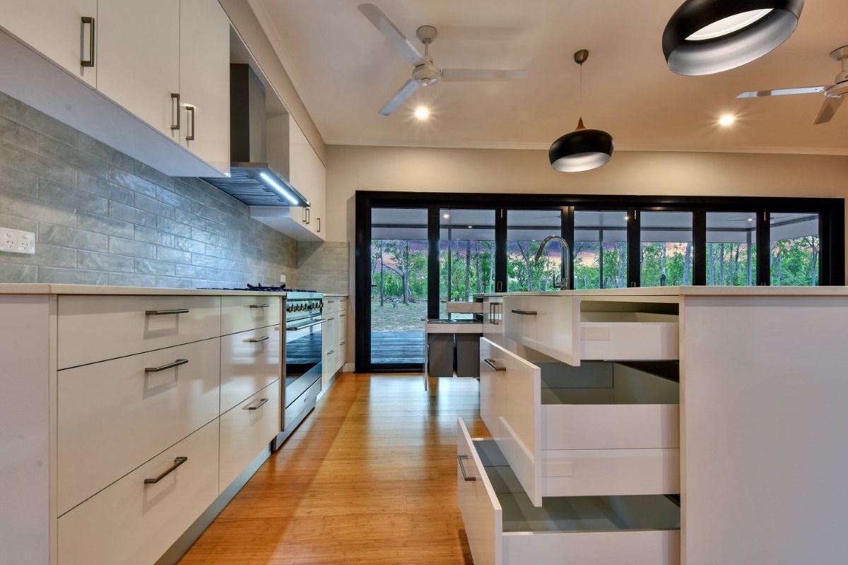 A Kitchen With Lots Of Drawers And A Ceiling Fan — SLS Builders Pty Ltd in Humpty Doo, NT