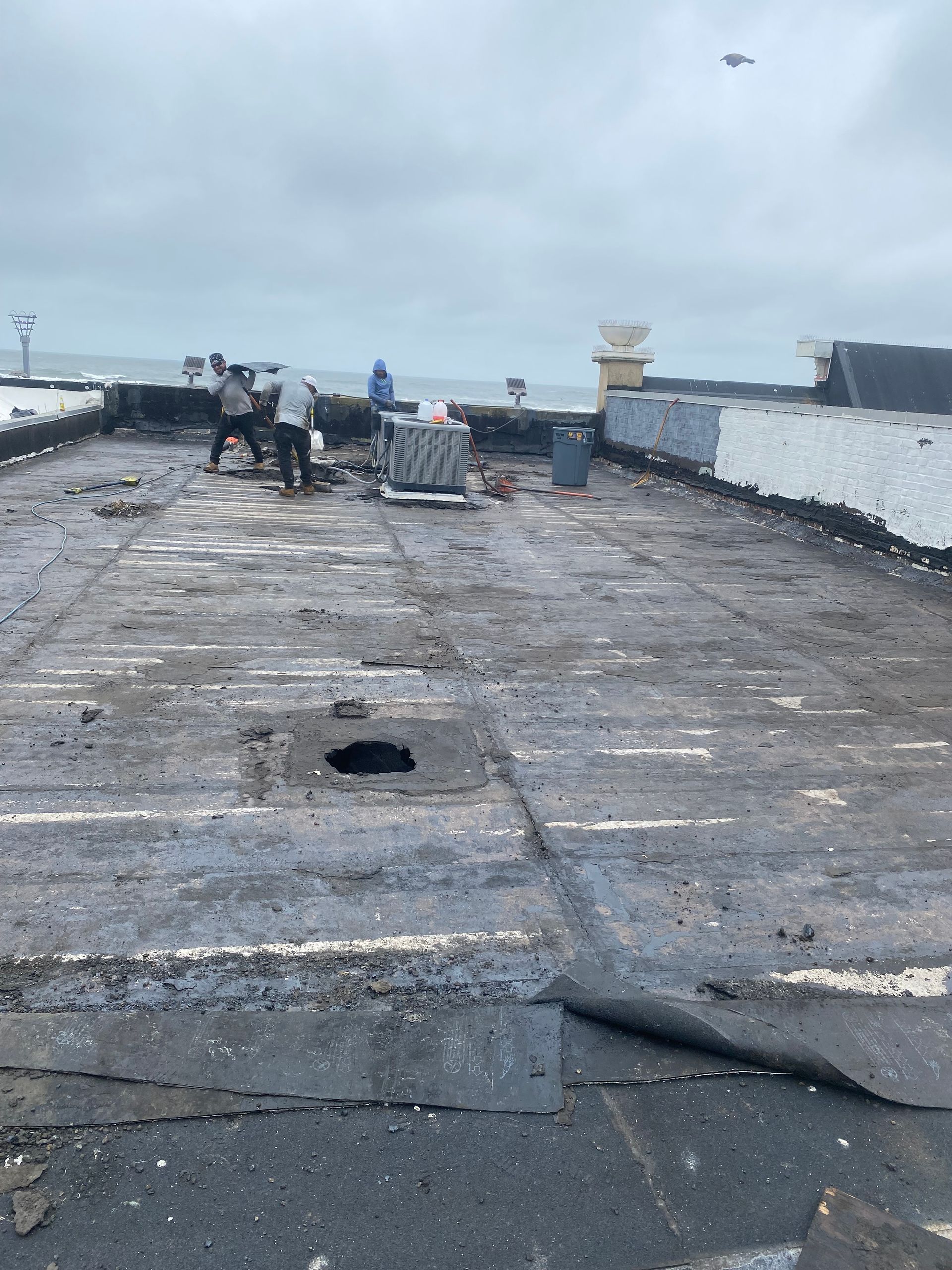 A group of people are working on the roof of a building.