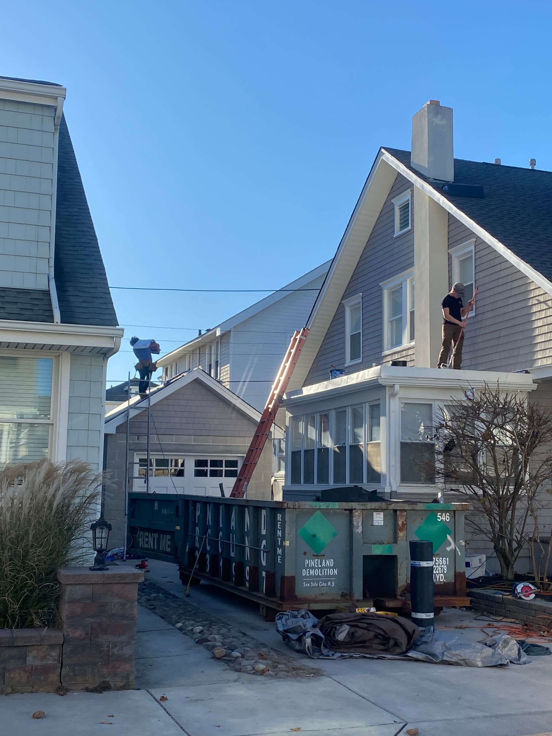 A man is working on the roof of a house
