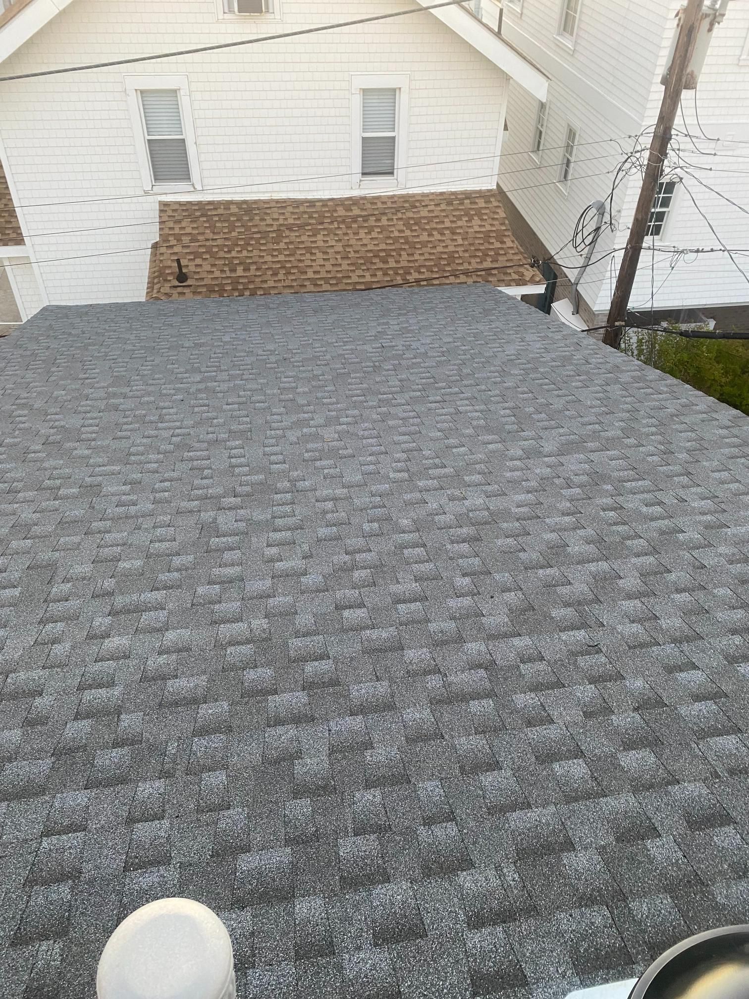 A person is standing on the roof of a house.