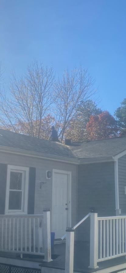 A house with a porch and a blue sky in the background.