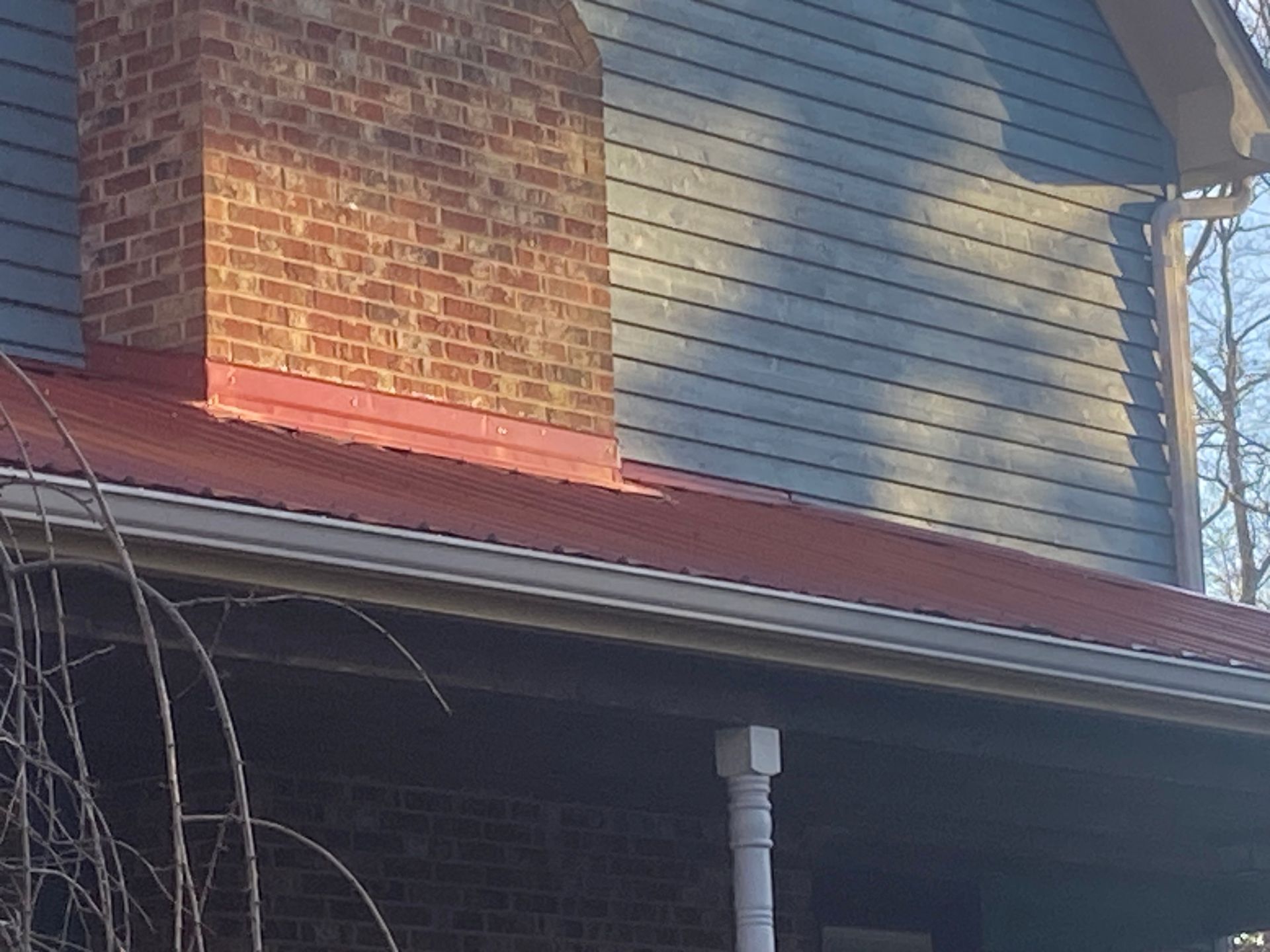 A house with a brick chimney on the side of it