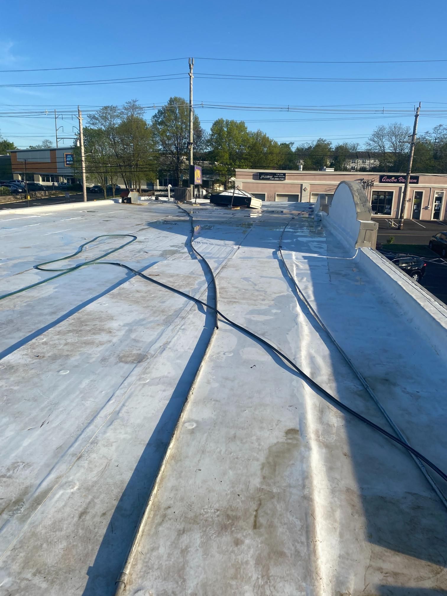 A roof with a lot of wires on it and a blue sky in the background.