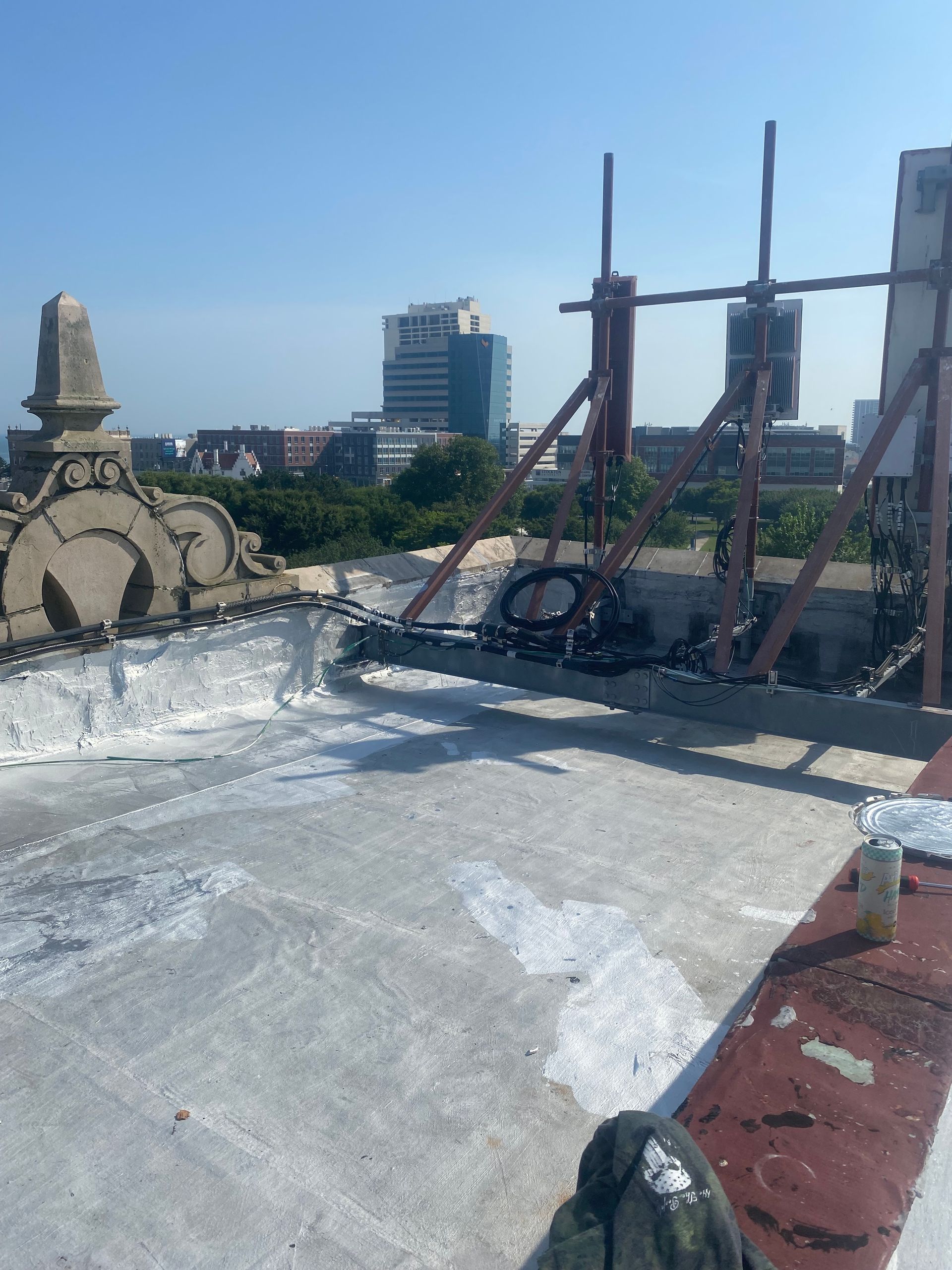 A person standing on a rooftop with a city in the background