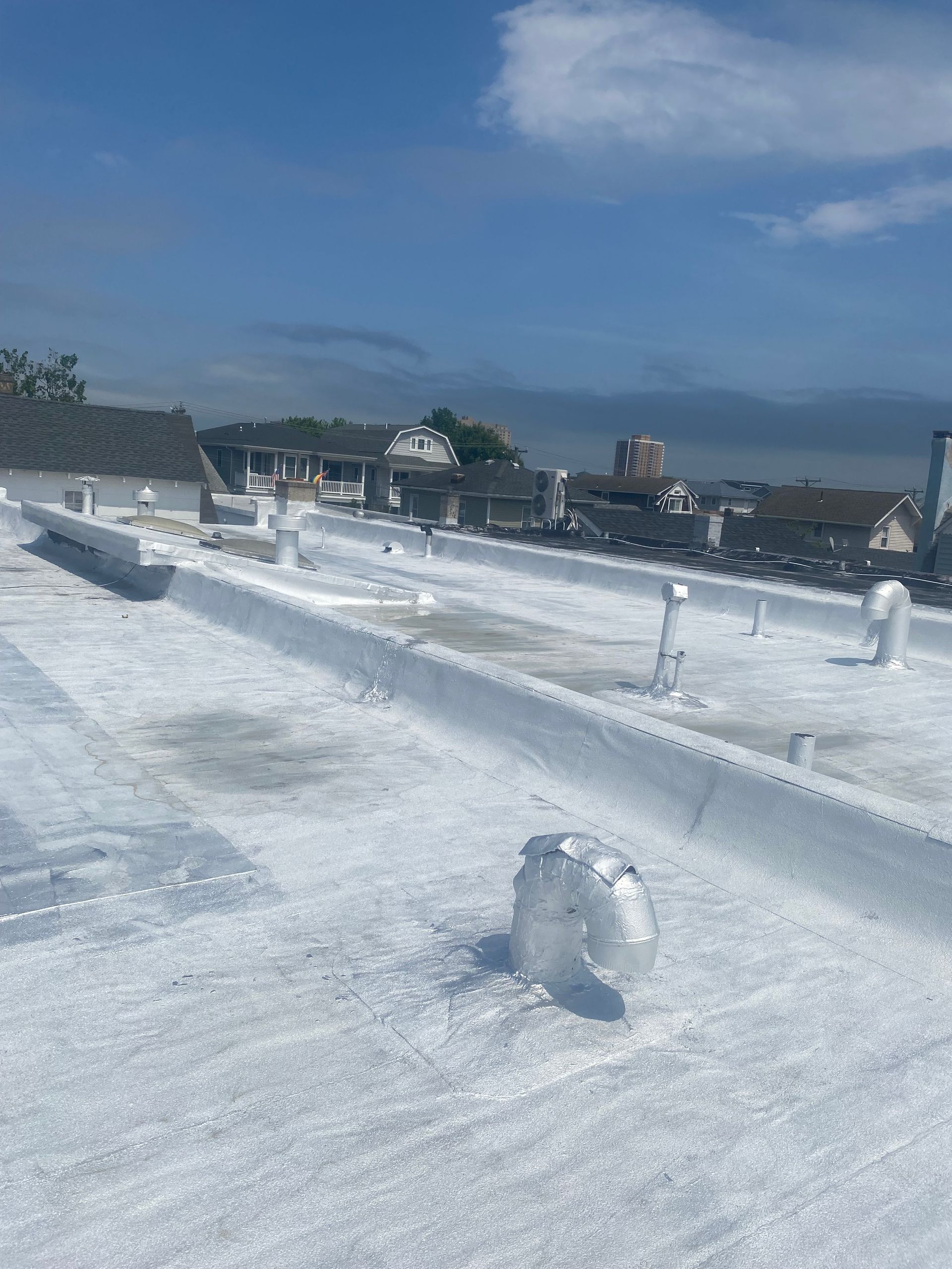 A white roof with a blue sky in the background.