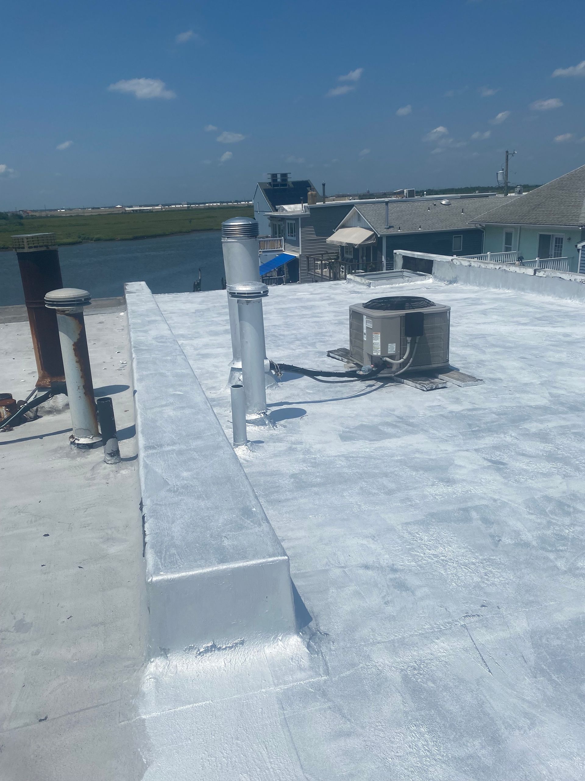 A man in a blue shirt is standing on a deck
