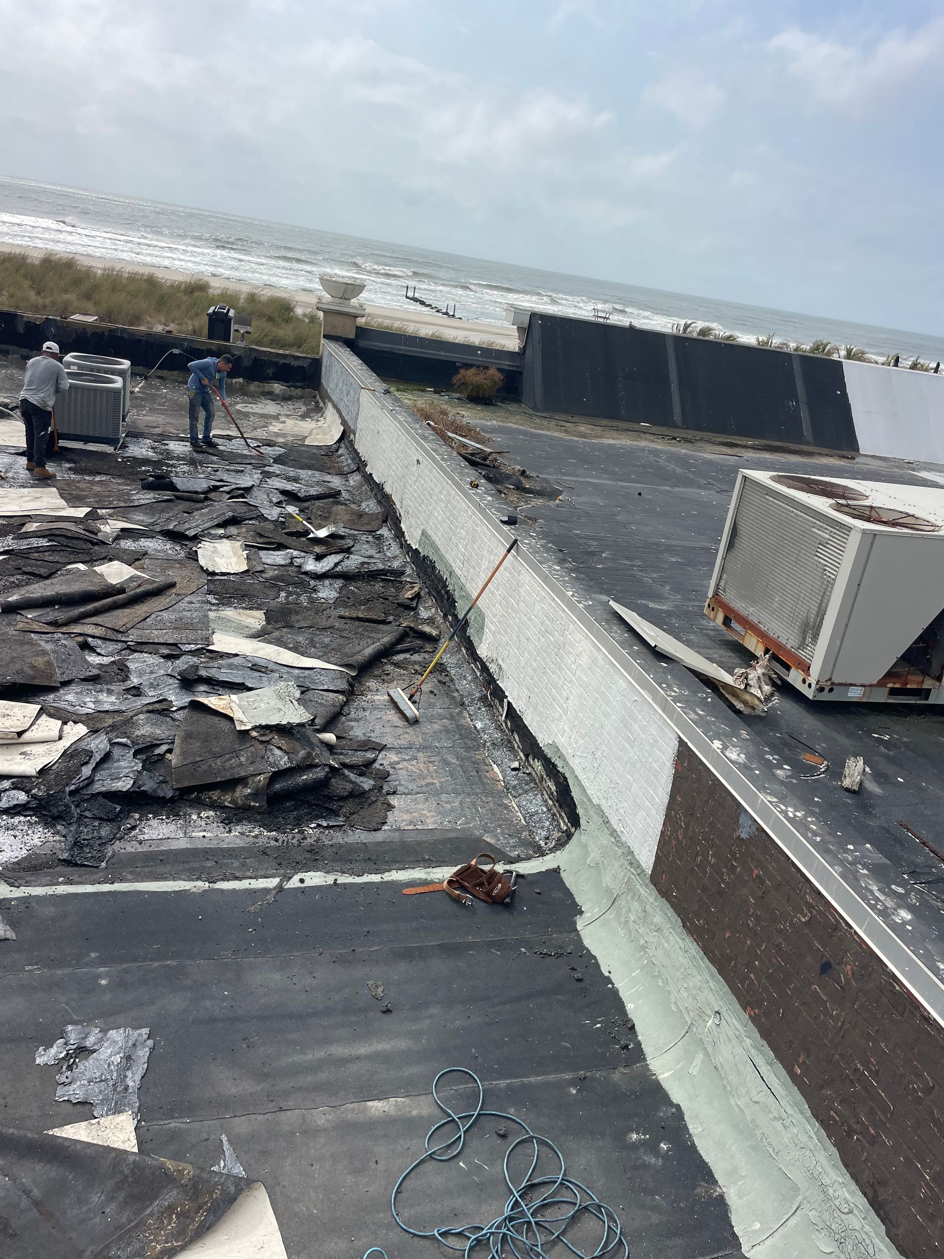 A roof that has been damaged by a storm and is being repaired.