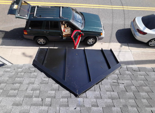 A green suv is parked on a roof with its trunk open