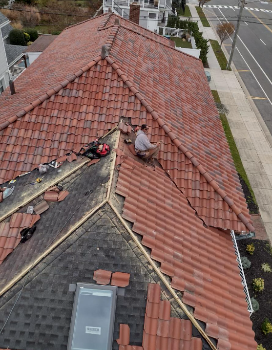 A man is working on the roof of a house