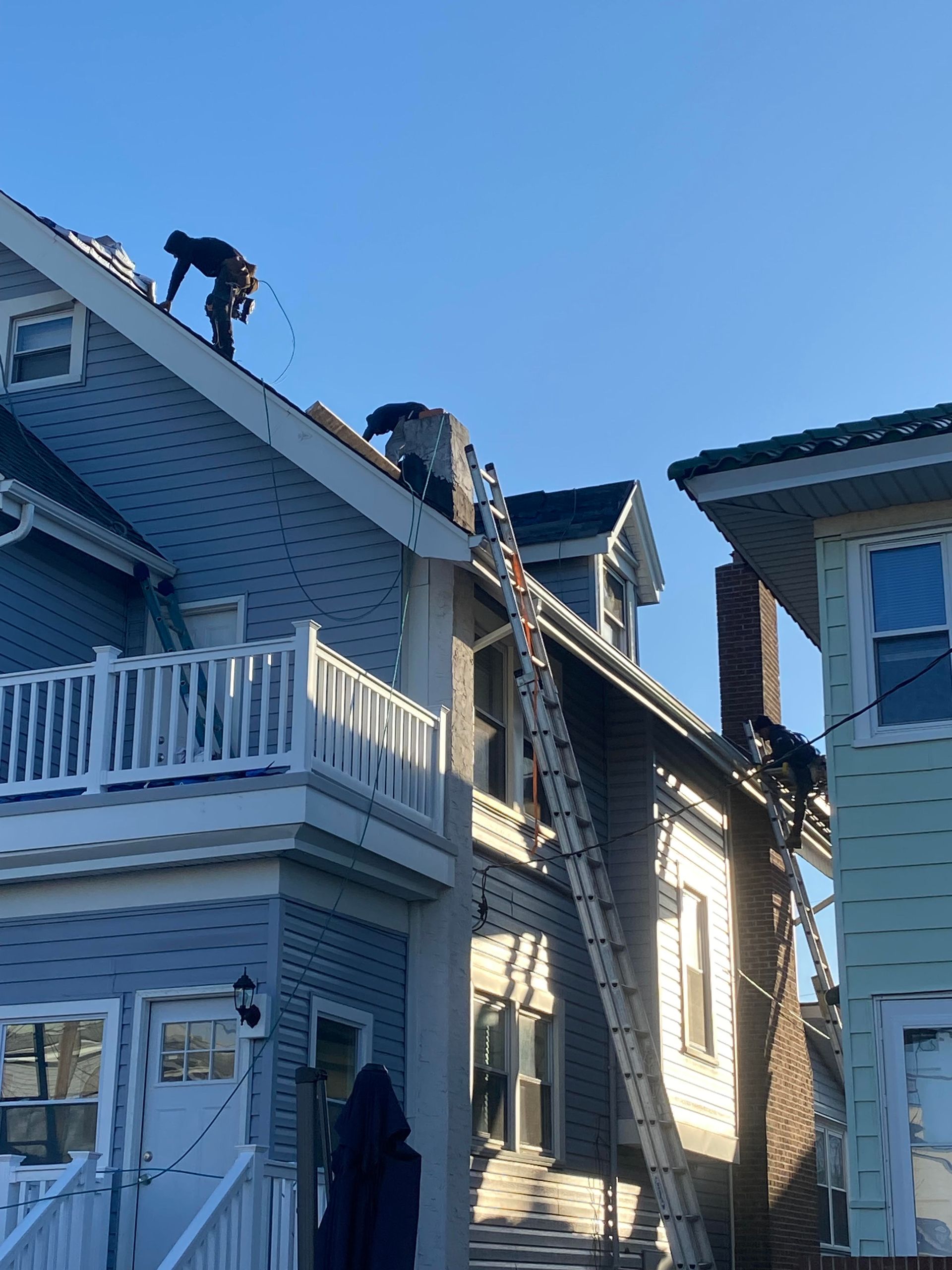 A man is working on the roof of a house.