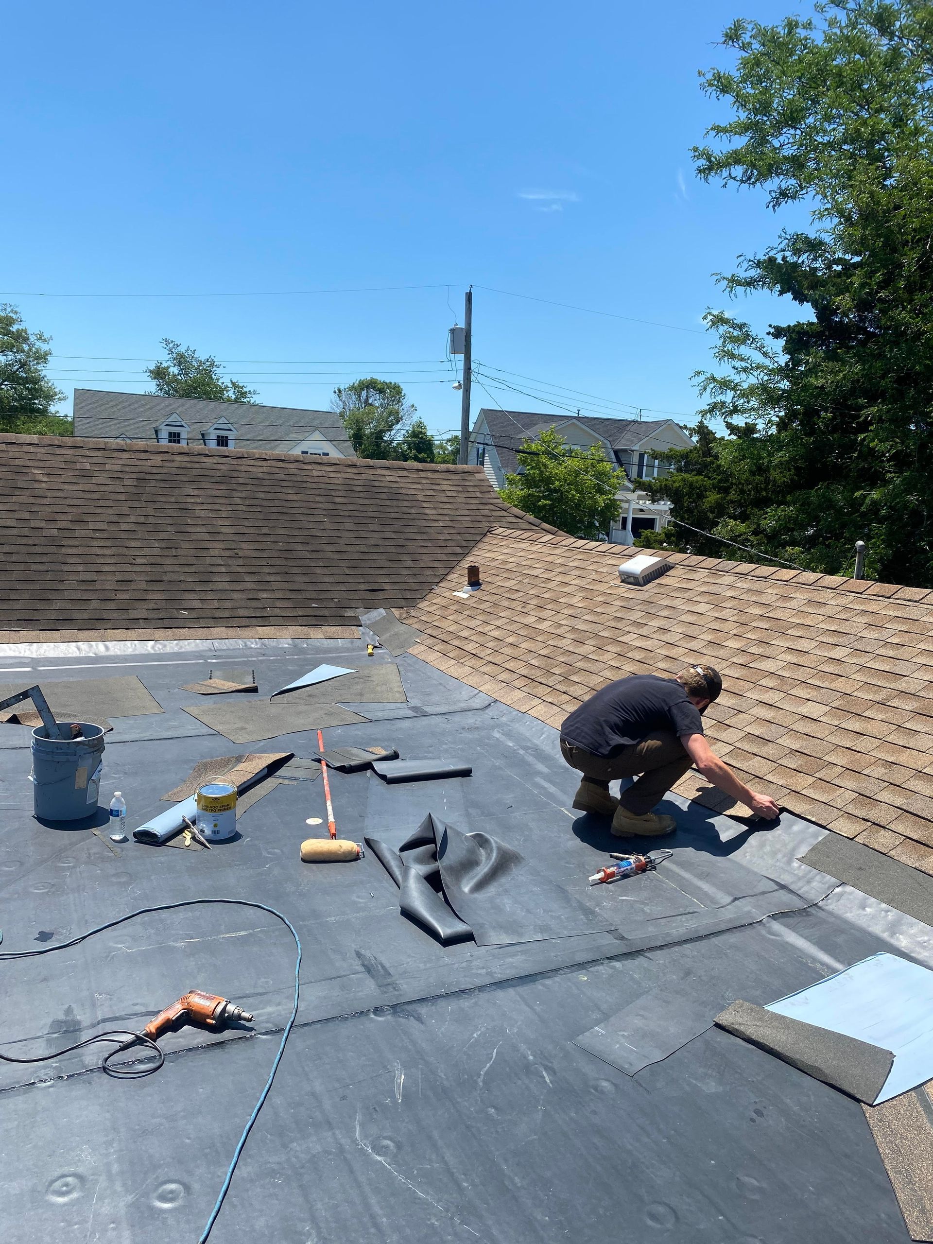 A man is working on the roof of a building.