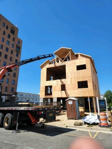 A crane is being used to lift a large wooden building